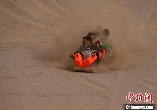 6月13日，敦煌鳴沙山月牙泉景區(qū)舉辦滑沙比賽?！●T豆 攝